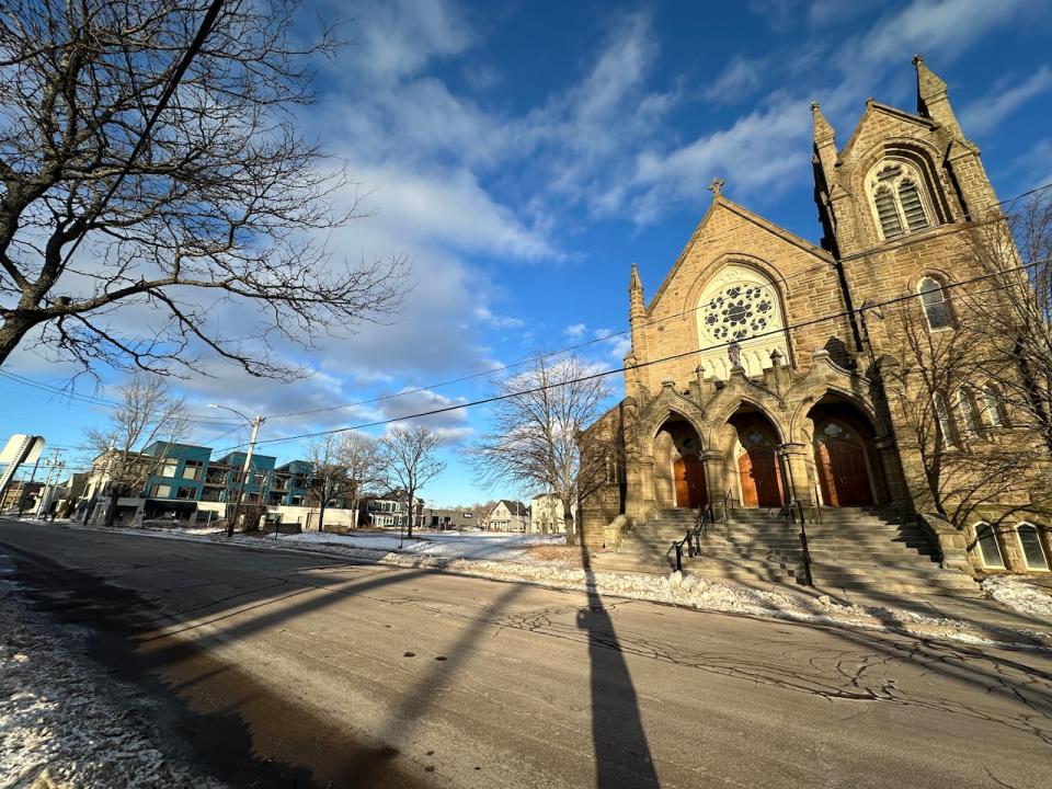 St. Bernard's Church shown Monday with the vacant land where the 18-storey tower is proposed off Botsford Street. 