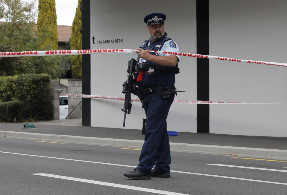 A police officer stands guard near the Masjid Al Noor mosque in Christchurch, New Zealand, Saturday, March 16, 2019, where one of the two mass shootings occurred. A white supremacist suspected in shootings at two mosques that killed 49 people during midday Friday prayers posted an anti-immigrant manifesto online and apparently used a helmet-mounted camera to broadcast live video of the slaughter on Facebook. (AP Photo/Vincent Yu)