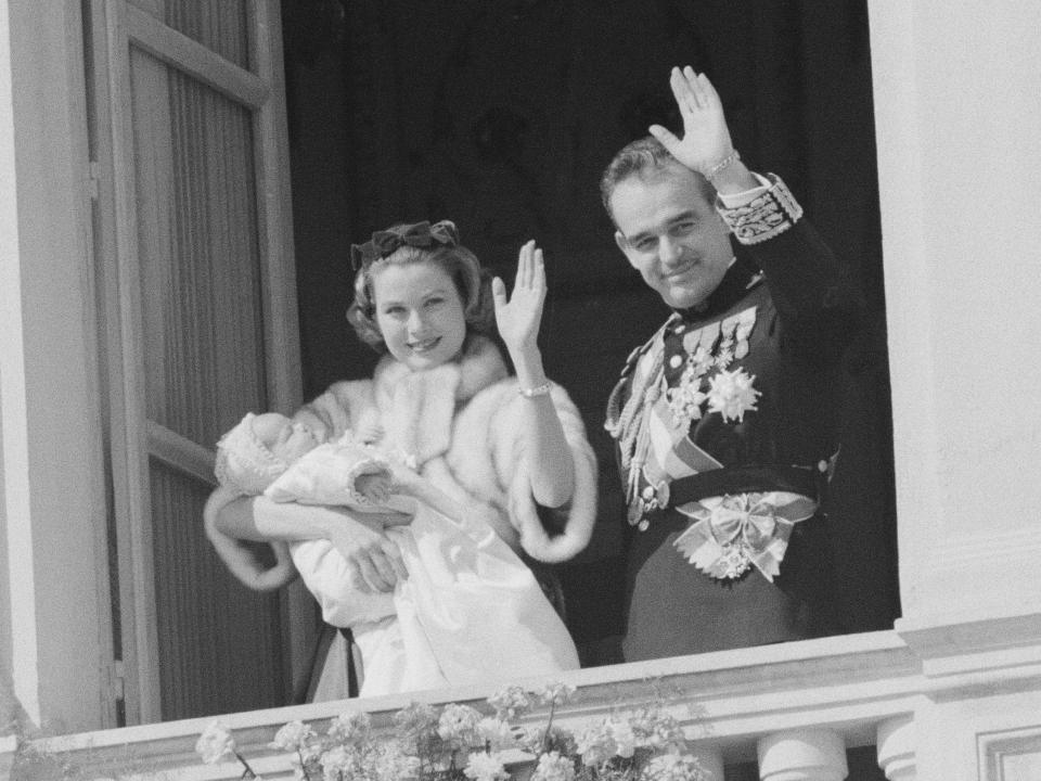 Princess Grace and Prince Rainier wave to the crowds after the baptizing of their daughter, Caroline, in 1957.