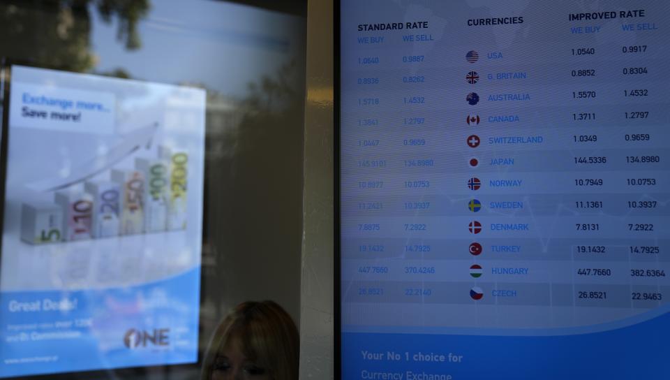 A screen of a currency exchange office shows the foreign exchange at Syntagma square in Athens, Greece, Wednesday, July 13, 2022. The euro on Tuesday fell to parity with the dollar for the first time in nearly 20 years. (AP Photo/Thanassis Stavrakis)