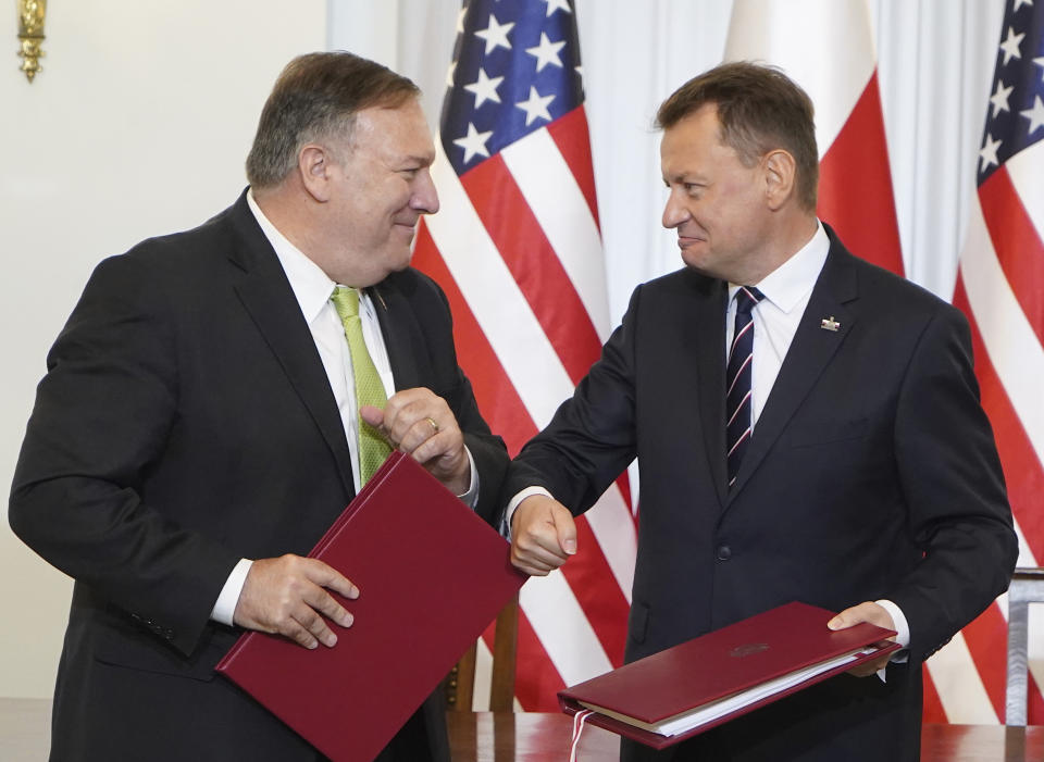 US Secretary of State Mike Pompeo, left, and Poland's Minister of Defence Mariusz Blaszczak greet each other after signing the US-Poland Enhanced Defence Cooperation Agreement in the Presidential Palace in Warsaw, Poland, Saturday Aug. 15, 2020. Pompeo is on a five day visit to central Europe. (Janek Skarzynski/Pool via AP)