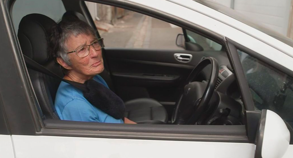 Melbourne woman Janette Fly trying to move her car. 