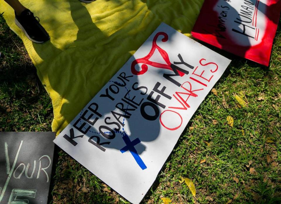 Kirsten Castillo, from Kendall, stands over her protest sign while attending the “Bans Off Our Bodies” rally at Ives Estates Park in Miami, Florida on Saturday, May 14, 2022. The rally was held in opposition of the leaked draft opinion from SCOTUS which aims to overturn Roe v. Wade, removing women’s constitutional right to an abortion.