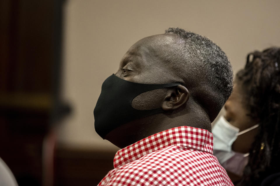 Marcus Arbery, center, father of Ahmaud Arbery, listens during the jury selection for the trial of Greg and Travis McMichael and their neighbor, William "Roddie" Bryan, at the Glynn County Courthouse, Monday, Oct. 25, 2021, in Brunswick, Ga. The three are charged with the slaying of his 25-year-old son in February 2020. (AP Photo/Stephen B. Morton, Pool)