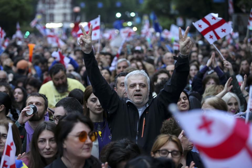 Demonstrators with Georgian national flags rally during an opposition protest against foreign influence bill and celebrating the Independence Day in the center of in Tbilisi, Georgia, Sunday, May 26, 2024. The opposition has denounced the bill as "the Russian law," because Moscow uses similar legislation to crack down on independent news media, nonprofits and activists critical of the Kremlin. (AP Photo/Zurab Tsertsvadze)