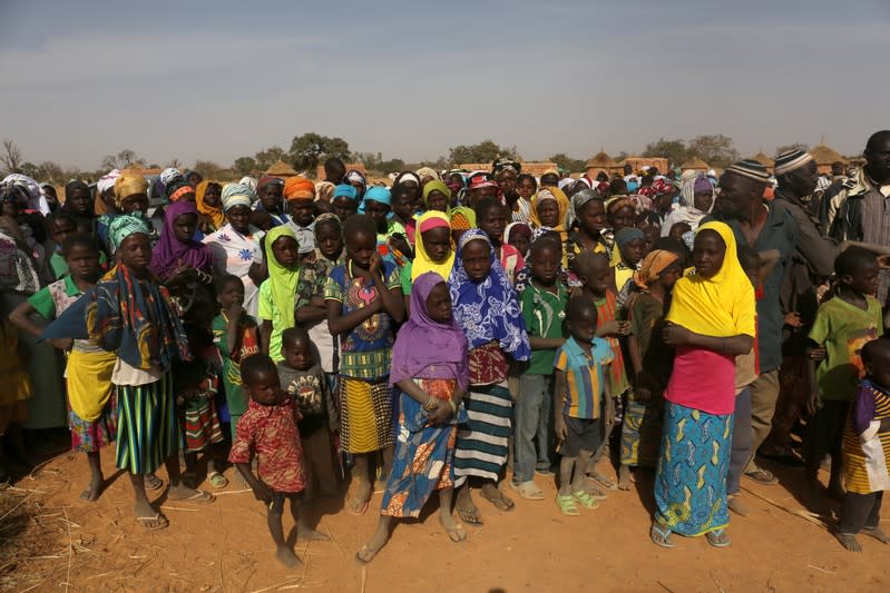 Displaced people wait for help at a village in Dablo area