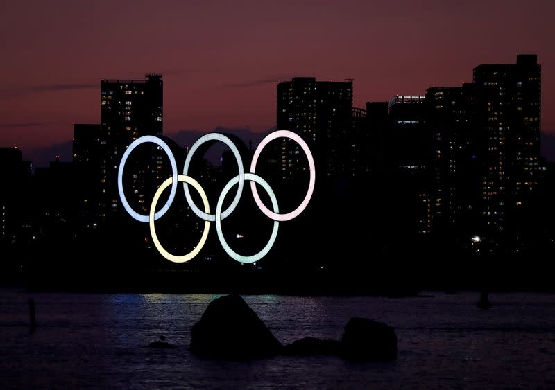 FILE PHOTO: The giant Olympic rings are seen in the dusk at the waterfront area at Odaiba Marine Park in Tokyo