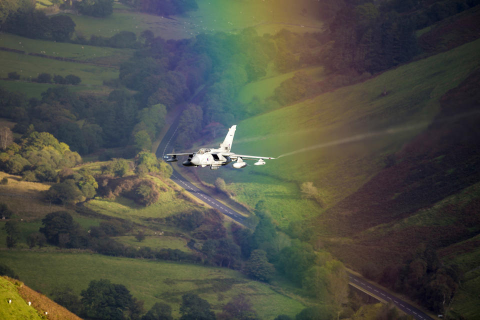 <p>A plane flies through a rainbow in Wales. (Photo: Caters News) </p>