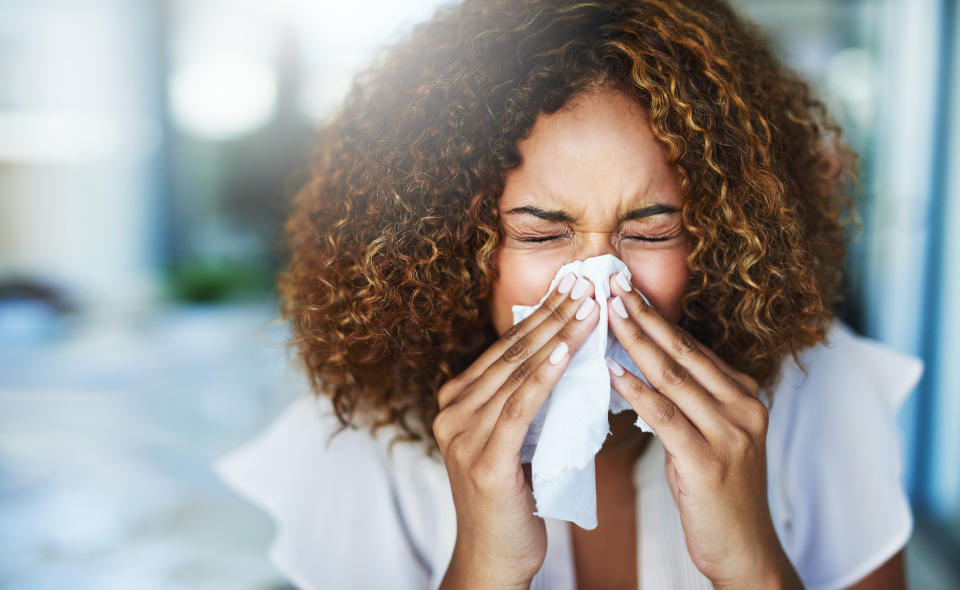 Hay fever season is here, pictured woman blowing her nose. (Getty Images)