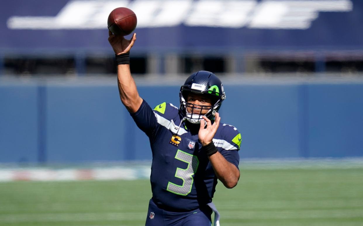 Seattle Seahawks quarterback Russell Wilson passes during warmups before an NFL football game against the Dallas Cowboys, Sunday, Sept. 27, 2020, in Seattle.  - AP