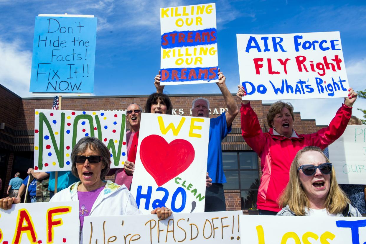 In this June 6, 2018 photo, residents demand answers and solutions outside of Robert J. Parks Library, in a rally for safe water before a Restoration Advisory Board meeting in Oscoda, Mich. These residents are asking the Air Force to claim responsibility for damages after findings of high levels of the toxic chemical PFOS in the foam near a plume coming from the former nuclear bomber base. 