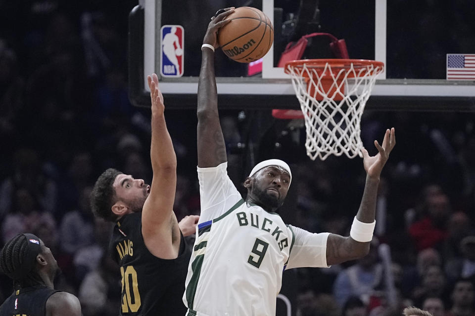 Milwaukee Bucks forward Bobby Portis (9) reaches for a rebound next to Cleveland Cavaliers forward Georges Niang during the first half of an NBA basketball game Wednesday, Jan. 17, 2024, in Cleveland. (AP Photo/Sue Ogrocki)