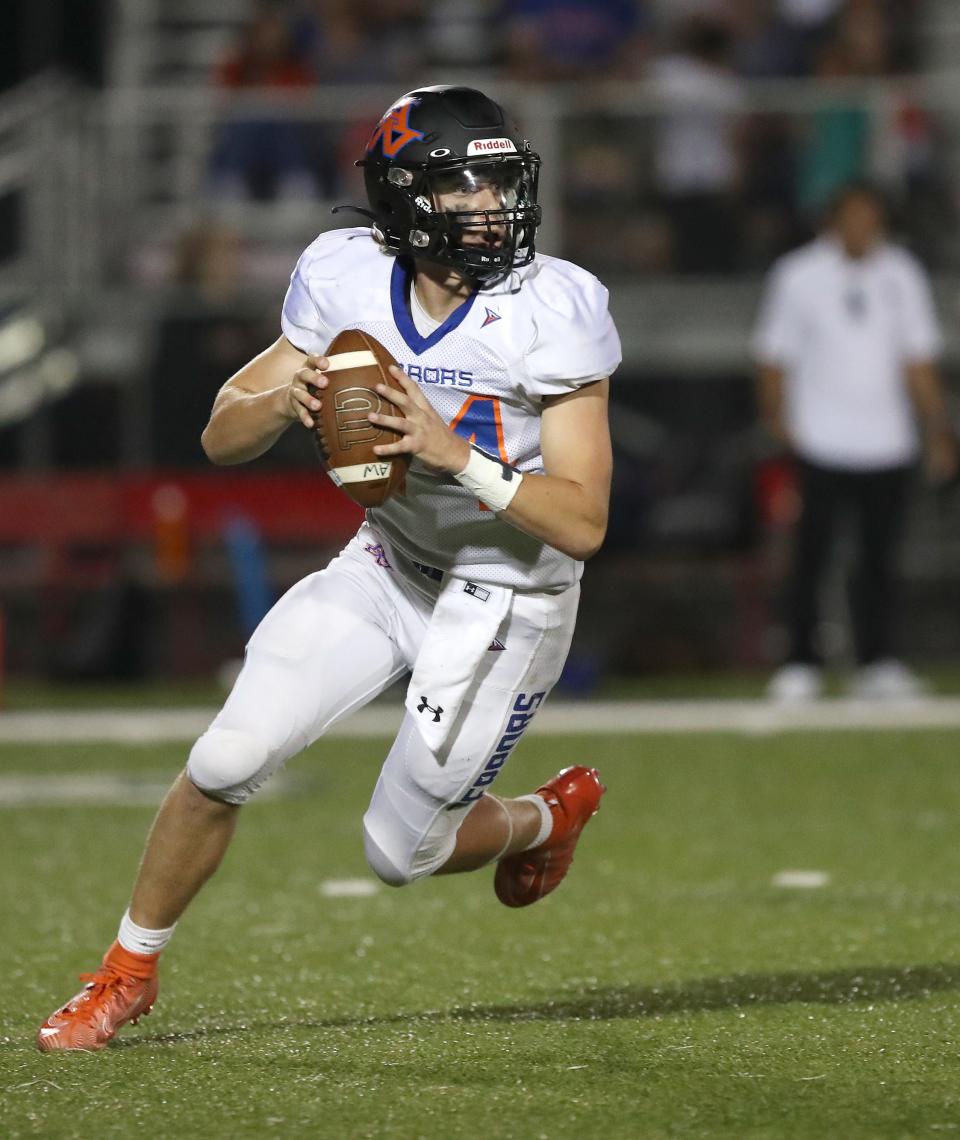 Appleton West's Ryder Hoffman rolls out to pass during their game at Appleton East last season.