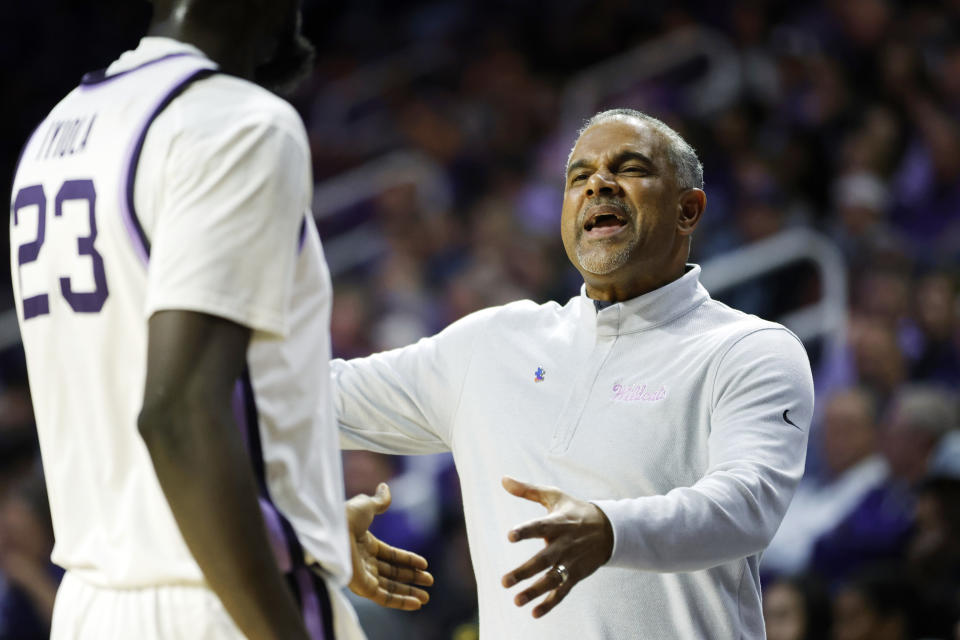 Kansas State head coach Jerome Tang congratulates Kansas State center Abayomi Iyiola (23) as he heads to the bench during the first half of an NCAA college basketball game, Tuesday, Feb. 21, 2023, in Manhattan, Kan. (AP Photo/Colin E. Braley)