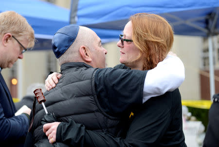 FILE PHOTO: Vigil attendees comfort one another outside the Tree of Life synagogue, in Pittsburgh, Pennsylvania, U.S., November 3, 2018. REUTERS/Alan Freed/File Photo