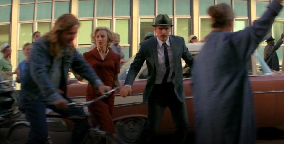 Jake and Sadie running past Randall Flagg on a bicycle in "11.22.63)