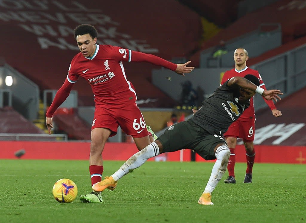 Trent Alexander-Arnold carries the ball under pressure (Getty)
