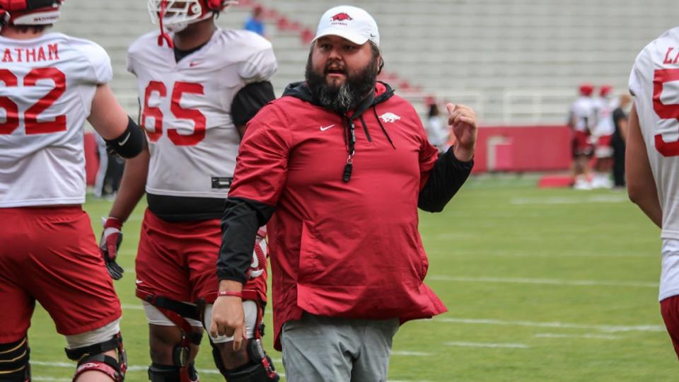 Arkansas OL coach Cody Kennedy directs his offensive line through drills during fall camp ahead of the 2022 season.