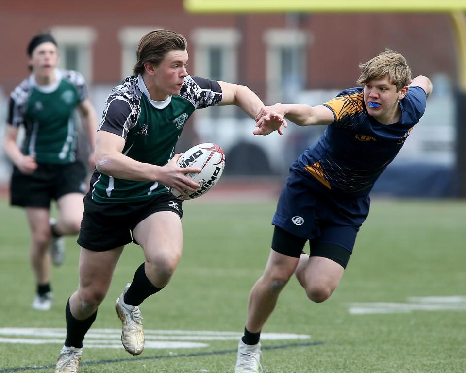 Marshfield's Jack Regan looks to escape a Hanover defender during first half action of their game against Hanover at Hanover High on Friday, April 29, 2022.