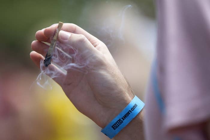 A festivalgoer smokes marijuana at Lollapalooza on July 29, 2021, at Grant Park in Chicago.