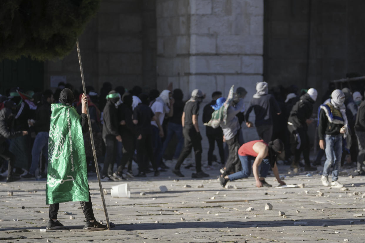 Palestinians clash with Israeli security forces at the Al Aqsa Mosque compound in Jerusalem's Old City Friday, April 15, 2022. (AP Photo/Mahmoud Illean)