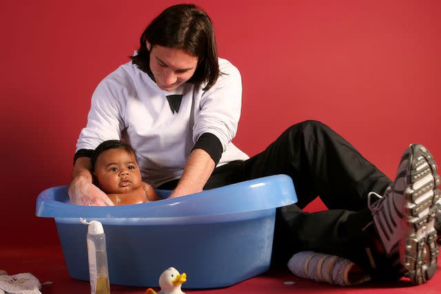 <p>Joan Monfort/AP</p> Lionel Messi holding Lamine Yamal in 2007