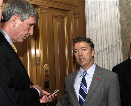 Senator Rand Paul (R-KY) (R) talks to reporters outside of the Senate chamber after voting on the U.S. budget bill in Washington December 18, 2013. REUTERS/Gary Cameron