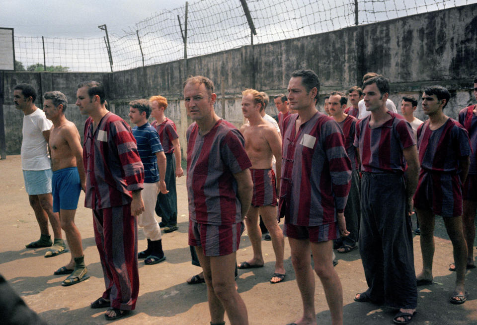 U.S. prisoners of war stand in the yard at Hanois Nga Tu So prison during an inspection visit by international observers and invited Western journalists, March 1973. The prison, surrounded by a high brick wall topped with barbed wire, had been a government building before the war. Each cell housed about a dozen POWs, and beds consisted of wooden platforms with mats. (AP Photo/Horst Faas)