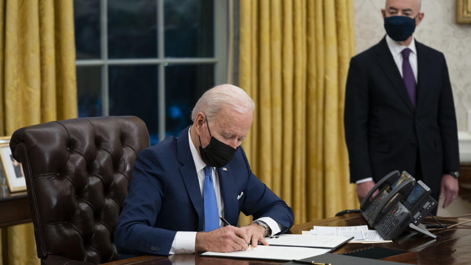 In this Tuesday, Feb. 2, 2021, file photo, Secretary of Homeland Security Alejandro Mayorkas looks on as President Joe Biden signs an executive order on immigration, in the Oval Office of the White House in Washington. (Evan Vucci/AP Photo)