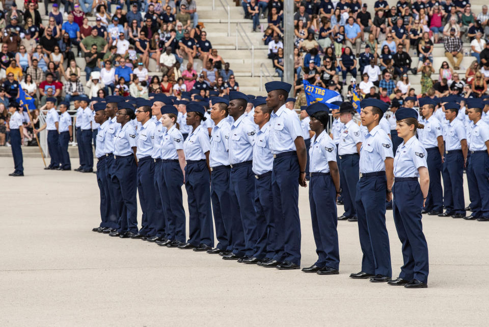Airmen assigned to the 326th Training Squadron and 91 Guardians assigned to 1st Delta Operations Squadron Detachment 1 graduate from Basic Military Training on April 26, 2023, at Joint Base San Antonio-Lackland, Texas. The U.S. military has struggled to overcome recruiting shortfalls and as a way to address that problem, it's stepping up efforts to sign up immigrants, offering a fast track to American citizenship to those who join the armed services. The front row of 14 graduates were part of the first group who graduated from basic training and were sworn in as new citizens under the new initiative. (Christa D'Andrea/U.S. Air Force via AP)