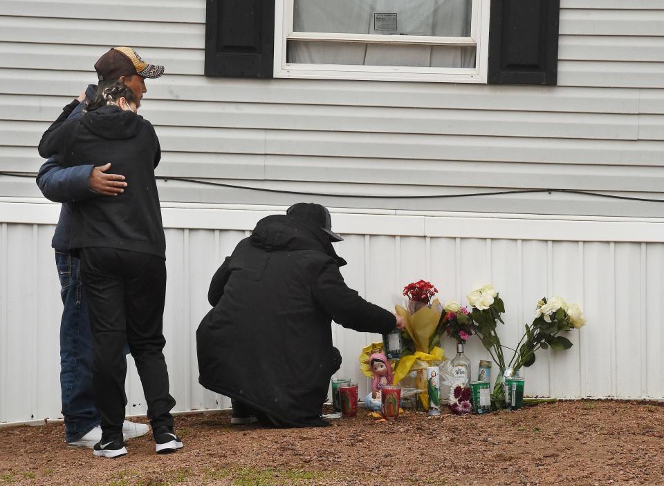 Mourners organize a memorial, Monday, May 10, 2021, outside a mobile home in Colorado Springs, Colo., where a shooting at a party took place a day earlier that killed six people before the gunman took his own life. 