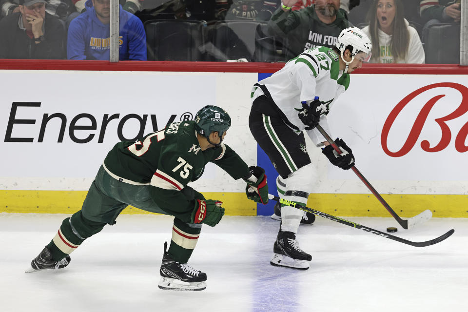 Dallas Stars left wing Mason Marchment (27) is defended by Minnesota Wild right wing Ryan Reaves (75) during the first period of Game 3 of an NHL hockey Stanley Cup first-round playoff series Friday, April 21, 2023, in St. Paul, Minn. (AP Photo/Stacy Bengs)