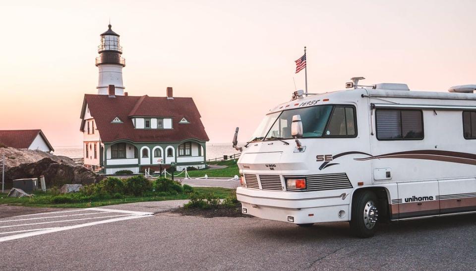 the exterior of the walker family RV in front of a lighthouse