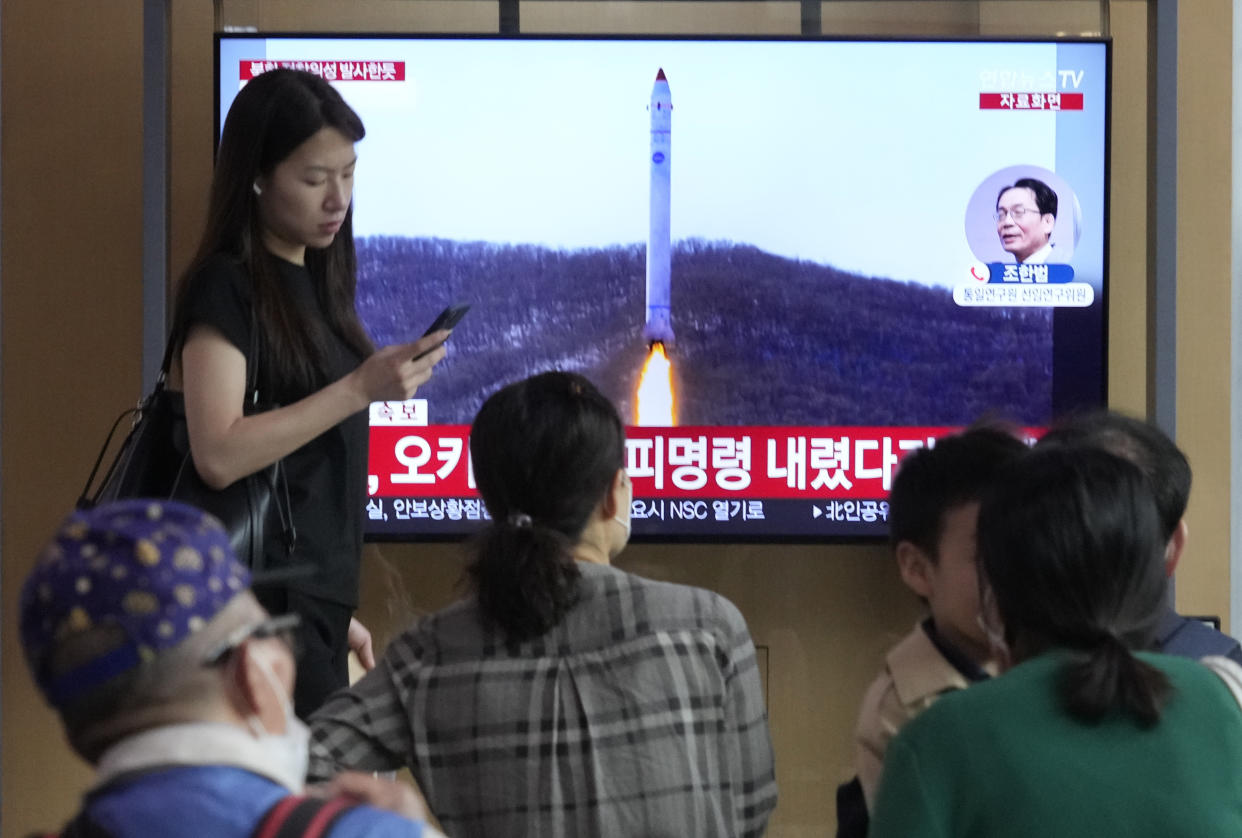 A TV screen shows a file image of North Korea's rocket launch during a news program at the Seoul Railway Station in Seoul, South Korea, Wednesday, May 31, 2023. North Korea launched a purported rocket Wednesday, a day after the country announced a plan to put its first military spy satellite into orbit, South Korea's military said. (AP Photo/Ahn Young-joon)