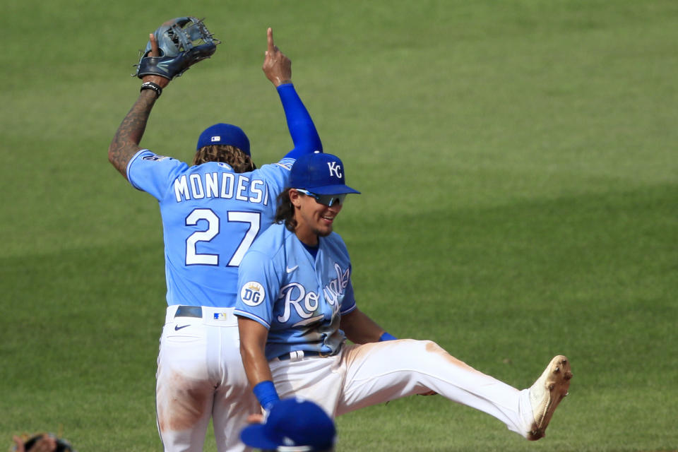 Kansas City Royals shortstop Adalberto Mondesi (27) and second baseman Nicky Lopez, right, celebrate following a baseball game against the Minnesota Twins at Kauffman Stadium in Kansas City, Mo., Sunday, Aug. 9, 2020. (AP Photo/Orlin Wagner)