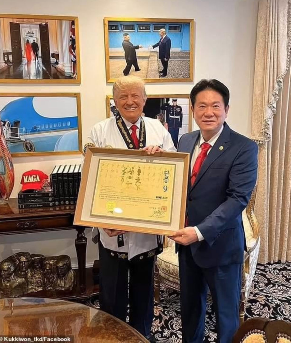 Mr Trump’s Mount Rushmore statue can be clearly seen in this photo with the president of Kukkiwon Taekwando Lee Dong-sup (Kukkiwon Taekwando)