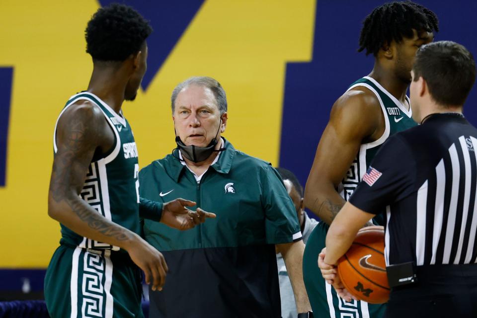 Michigan State coach Tom Izzo talks with guard Rocket Watts during the first half against Michigan on Thursday, March 4, 2021, at Crisler Center.