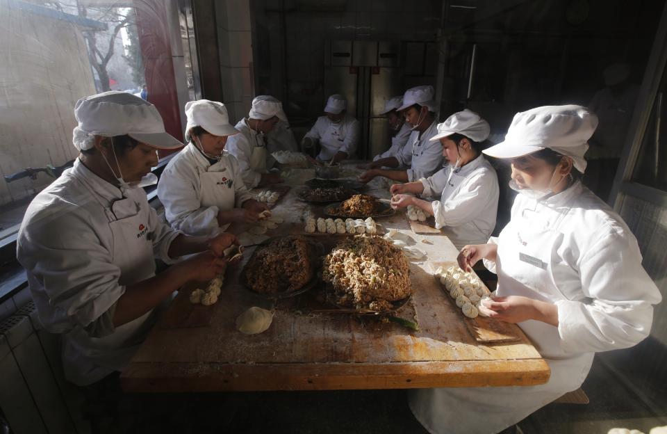 Staff make steamed buns at the Qing-Feng steamed buns restaurant where Chinese President Xi visited, in Beijing