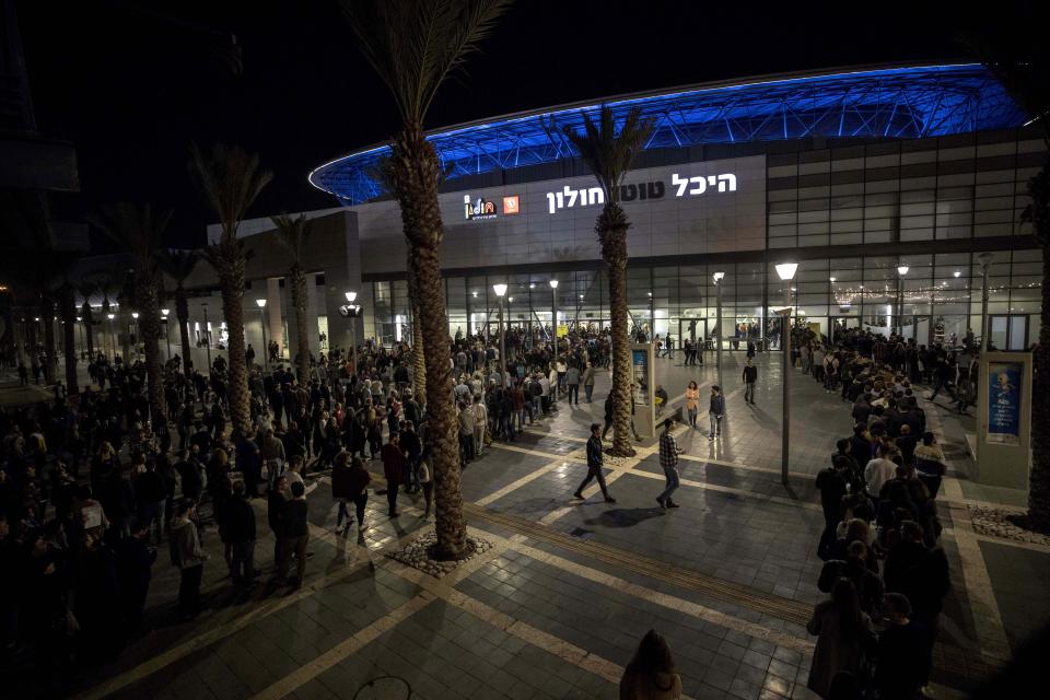 In this Thursday, Nov. 28, 2019 photo, Israelis wait in line to enter a show by Comedian Louis C.K. in the Israeli city of Holon near Tel Aviv. Two years after being swept up in the Me Too movement and acknowledging sexual misconduct with multiple women, comedian Louis C.K. took to the stage at a nearly packed basketball arena outside Tel Aviv, where the audience seemed ready to let it go.(AP Photo/Tsafrir Abayov)