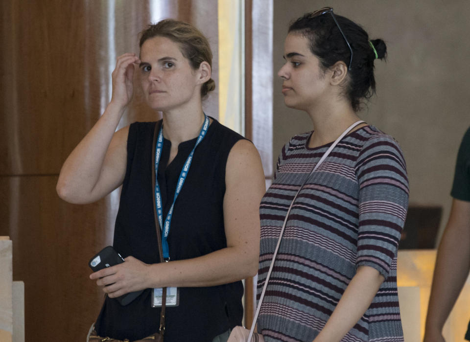 Rahaf Mohammed Alqunun, right, walks with an unidentified companion in Bangkok, Thailand, Friday, Jan. 11, 2019. Alqunun, the 18-year old Saudi woman who fled her family to seek asylum, remains in Thailand under the care of the U.N. refugee agency as she awaits a decision by a third country to accept her as a refugee. (AP Photo/Sakchai Lalit)