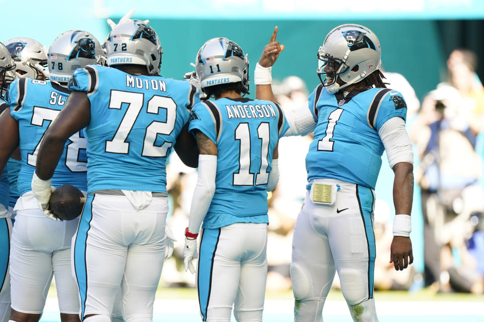 Carolina Panthers quarterback Cam Newton (1) celebrates a touchdown with the team during the first half of an NFL football game against the Miami Dolphins, Sunday, Nov. 28, 2021, in Miami Gardens, Fla. (AP Photo/Wilfredo Lee)