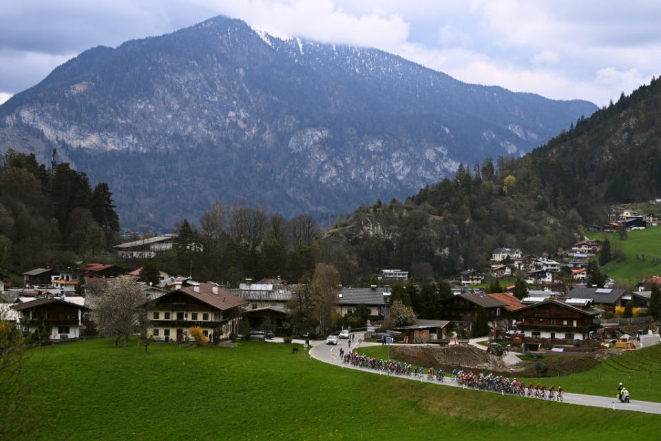 ALPBACH AUSTRIA  APRIL 17 A general view of the peloton passing through a Brixlegg village with mountainous landscape during the 46th Tour of the Alps 2023 Stage 1 a 1275km stage from Rattenberg to Alpbach 984m on April 17 2023 in Alpbach Austria Photo by Tim de WaeleGetty Images