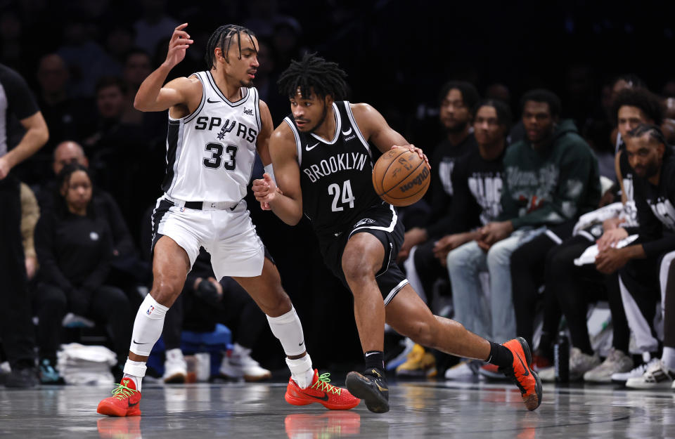 Brooklyn Nets guard Cam Thomas (24) drives to the basket against San Antonio Spurs guard Tre Jones (33) during the second half of an NBA basketball game, Saturday, Feb. 10, 2024, in New York. (AP Photo/Noah K. Murray)