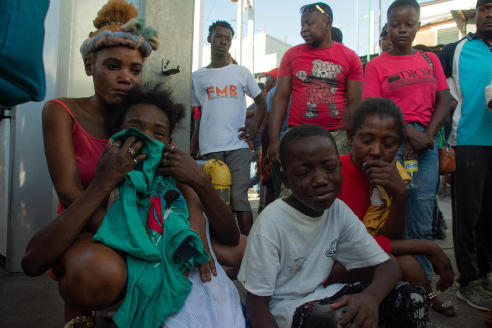 Residents react after a dozen people were killed in the street by gang members in Petion Ville, a suburb of Port-au-Prince, Haiti, March 18, 2024. / Credit: CLARENS SIFFROY/AFP/Getty