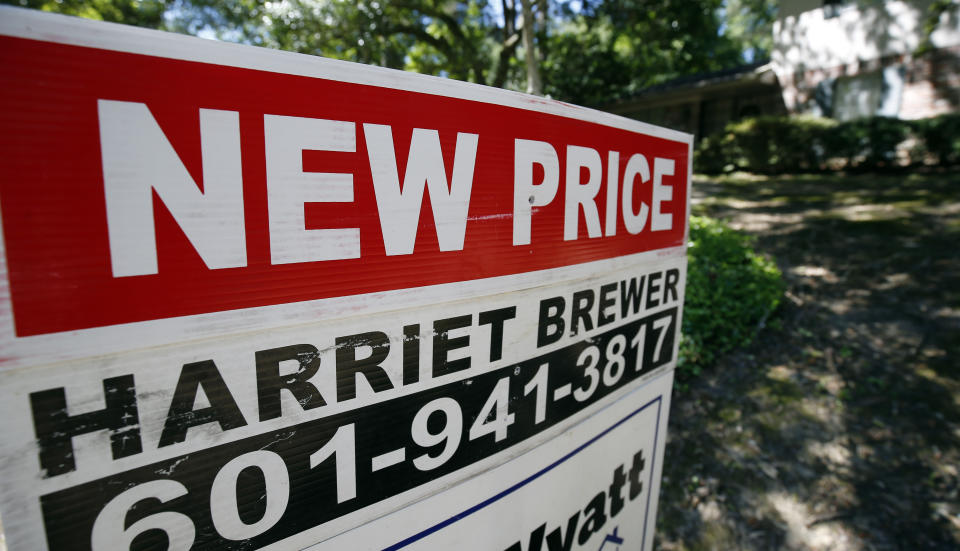 In this June 13, 2019, photo a house on the market has a "new price" sign fixed on the realtor's sign in northeast Jackson, Miss. On Tuesday, June 25, the Standard & Poor's/Case-Shiller 20-city home price index for April is released. (AP Photo/Rogelio V. Solis)