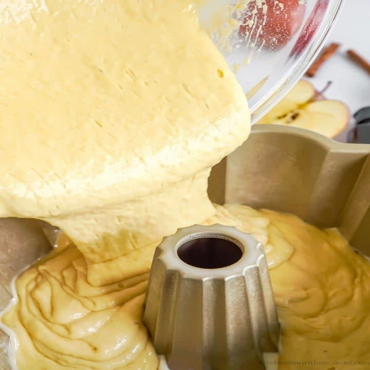 Pouring batter into a bundt pan.