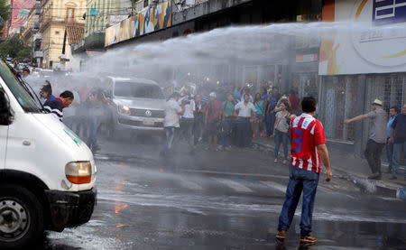 Protestors fight with the police during a demonstration against a possible change in the law to allow for presidential re-election in front of the Congress building in Asuncion, Paraguay, March 31, 2017. REUTERS/Jorge Adorno