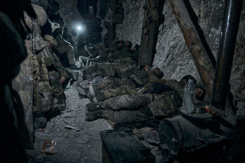 Soldiers of the Ukrainian 3rd Army Assault Brigade of the Special Operations Forces (SSO) "Azov" rest in a blindage after night fight near Bakhmut, Donetsk region, Ukraine, Saturday, Feb. 11, 2023.