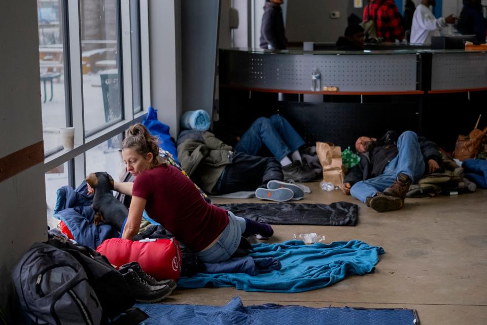 Laura Arnett sits with her dog, Toby, on Thursday inside the day shelter at the Homeless Alliance in Oklahoma City during a winter storm.