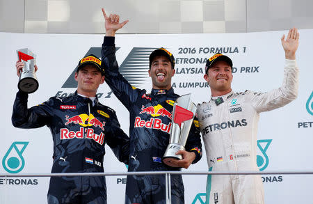 Formula One - F1 - Malaysia Grand Prix - Sepang, Malaysia- 2/10/16 Red Bull's Daniel Ricciardo of Australia (C), Red Bull's Max Verstappen of the Netherlands and Mercedes' Nico Rosberg of Germany celebrate on the podium. REUTERS/Edgar Su